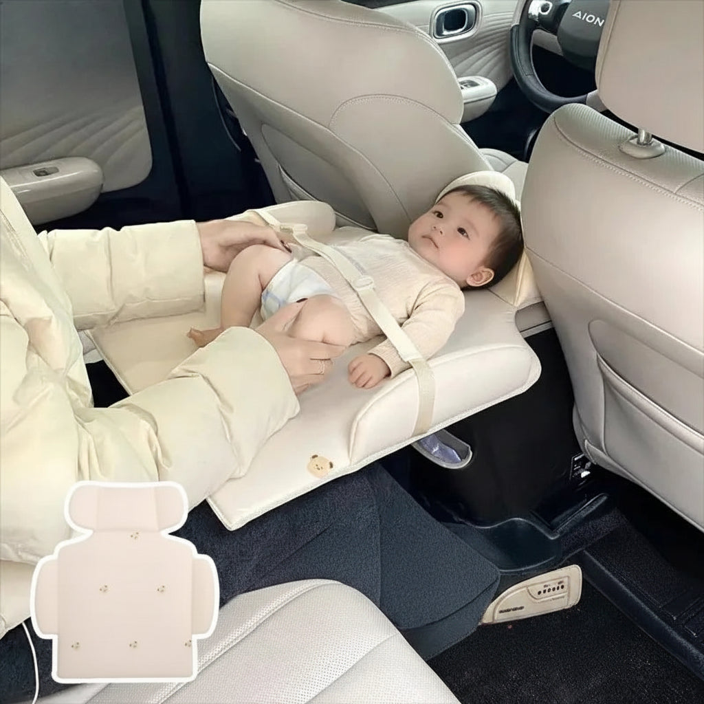 Beige portable baby changing pad for car back seat with safety harness and cute bear design.