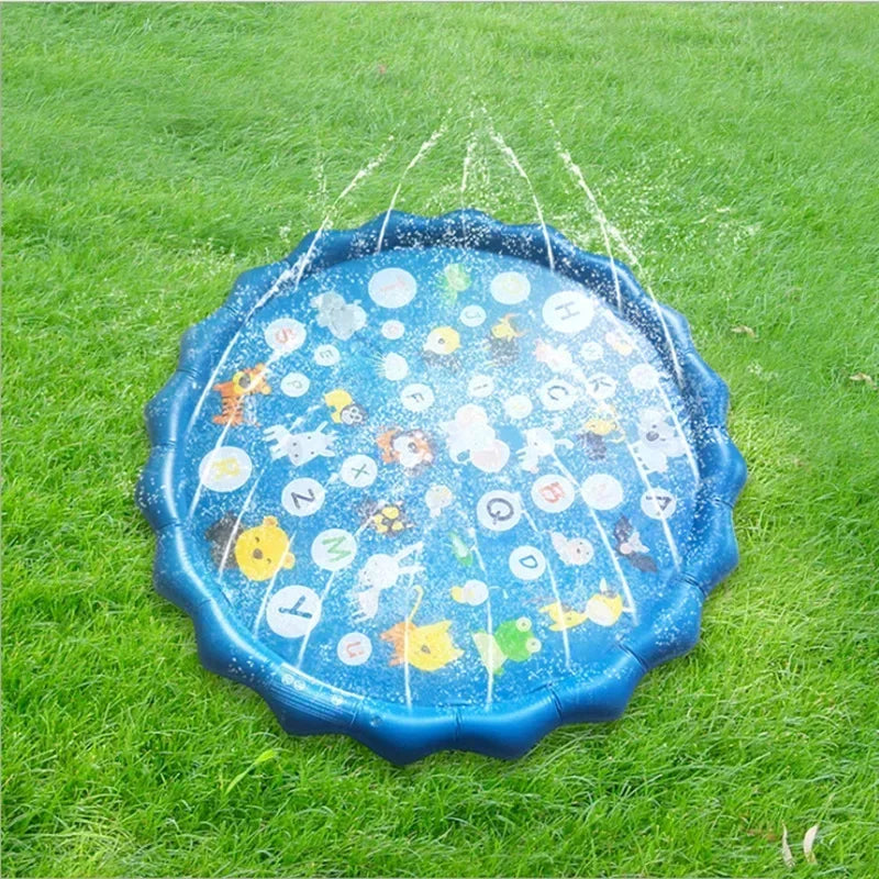 Blue inflatable splash pad for kids with animal and letter graphics, spraying water on green grass.