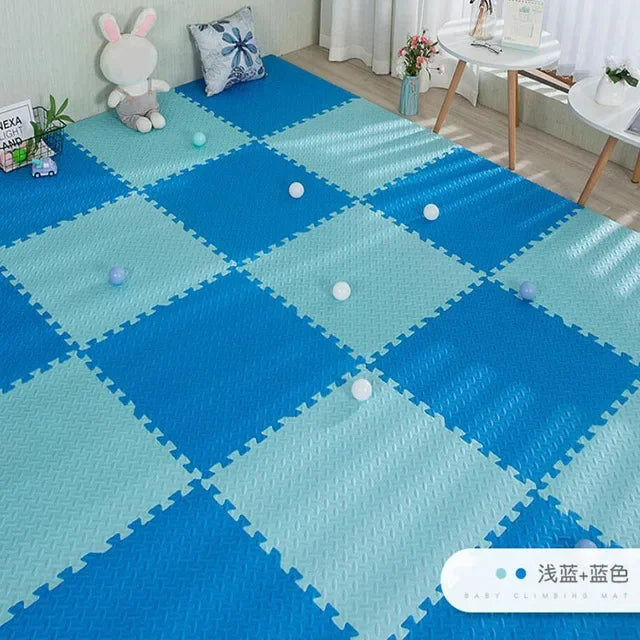 Blue and light blue interlocking EVA foam puzzle play mat for babies, with a textured surface.