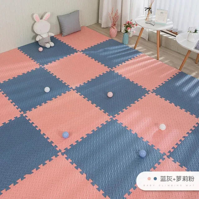 Pink and blue interlocking foam puzzle play mat for babies, with a textured surface.