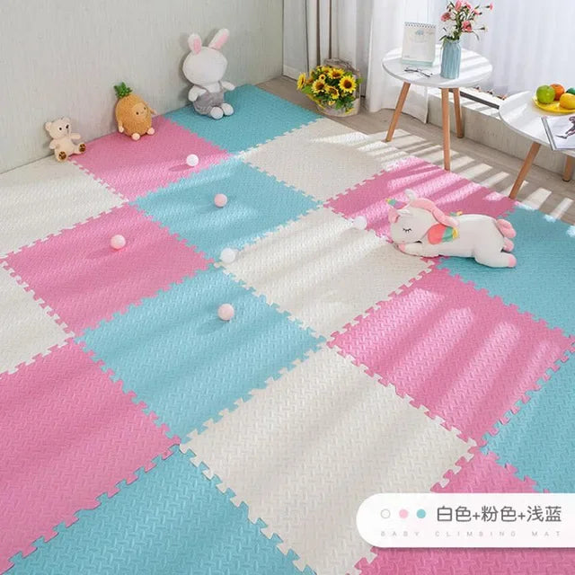 Pink, blue, and white interlocking EVA foam puzzle play mat for babies, with a textured surface.