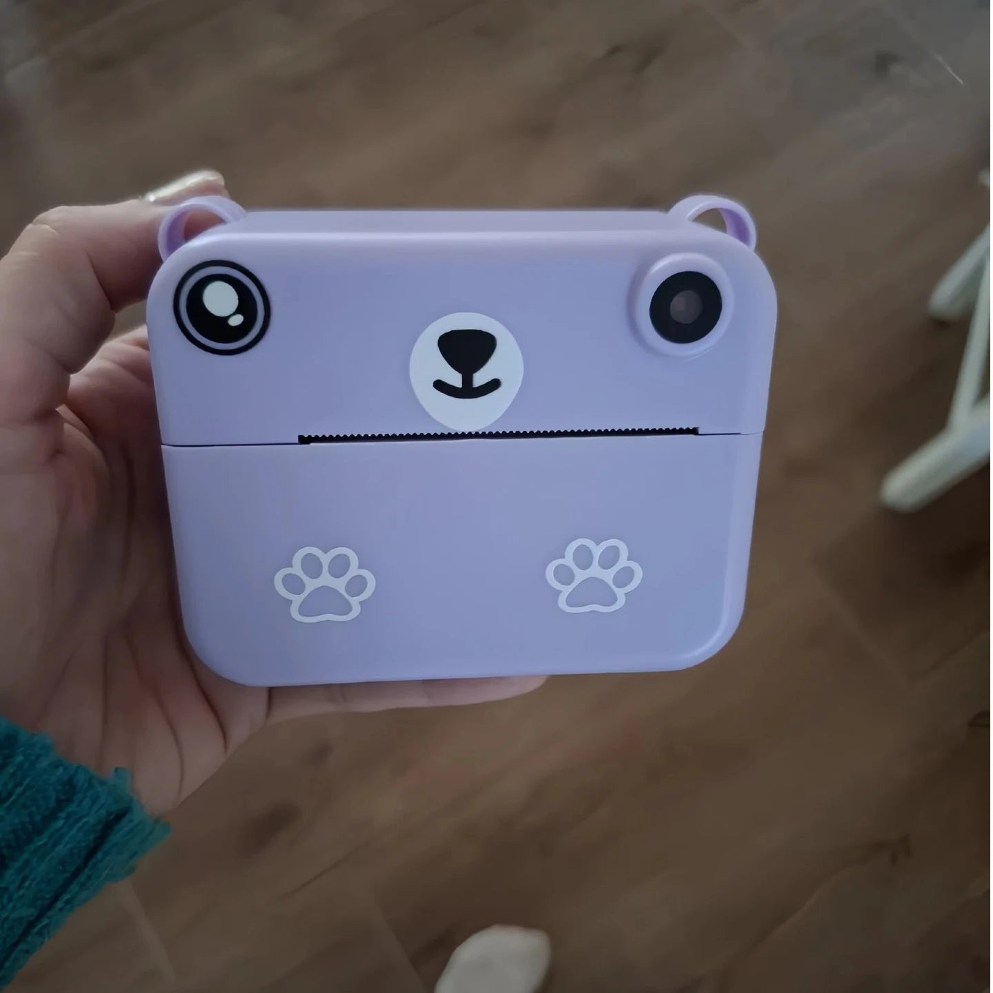 Purple bear-shaped instant print camera for kids with paw prints.