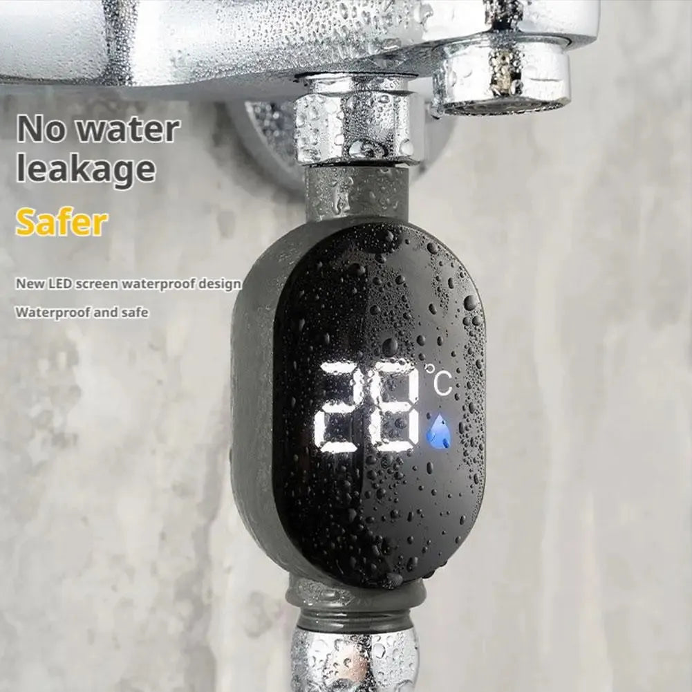 Black digital shower thermometer with LED display showing 28°C, attached to a chrome shower pipe.