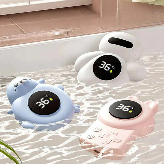 Three cute digital bath thermometers: a blue seal, a white octopus, and a pink game controller, floating in water.