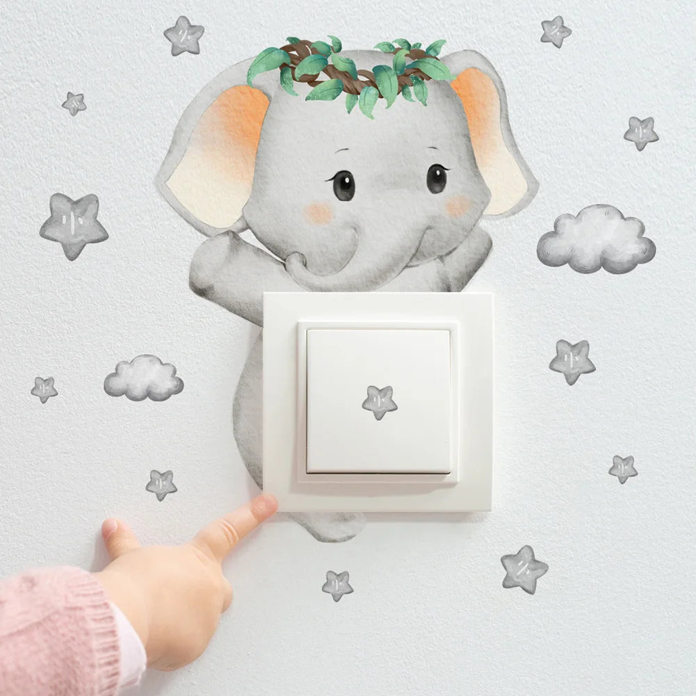 Watercolor elephant wall decal with green wreath, gray stars, and clouds around a light switch, touched by a child's finger.