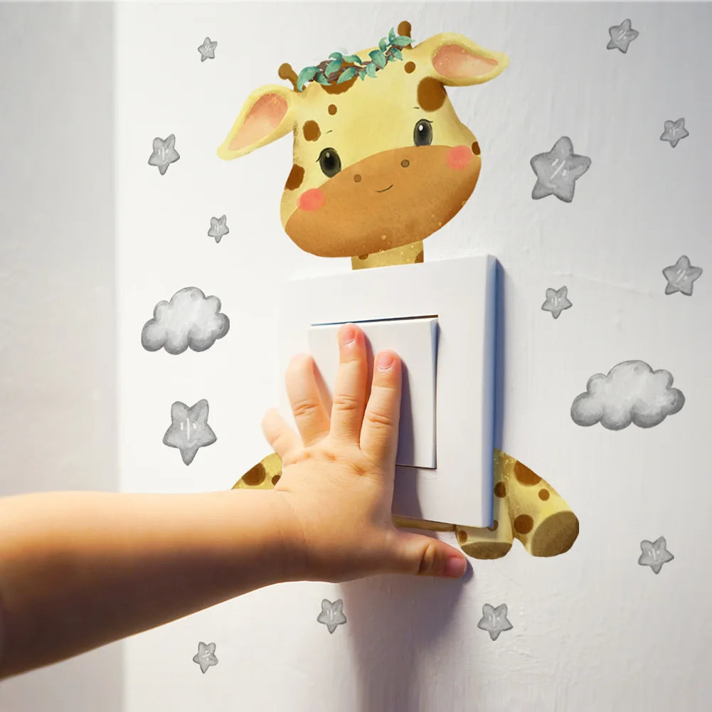 Cute giraffe wall decal with stars and clouds, perfect for a child's room, shown with a child's hand near a light switch.