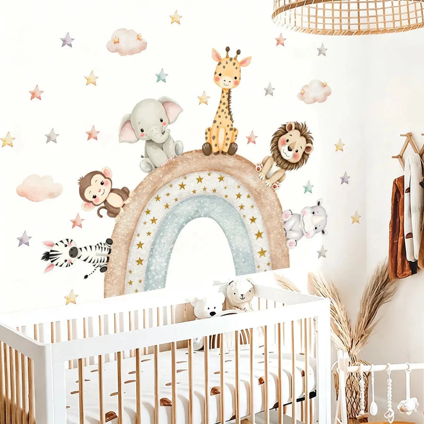 Colorful forest animal wall decals with a rainbow, stars, and clouds above a white baby crib.