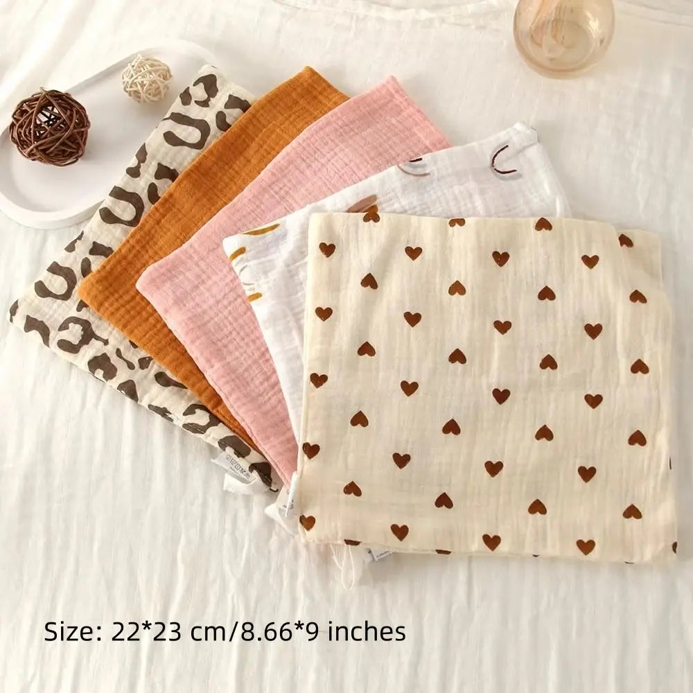 Soft cotton gauze baby towels in various colors and patterns, including hearts and leopard print.