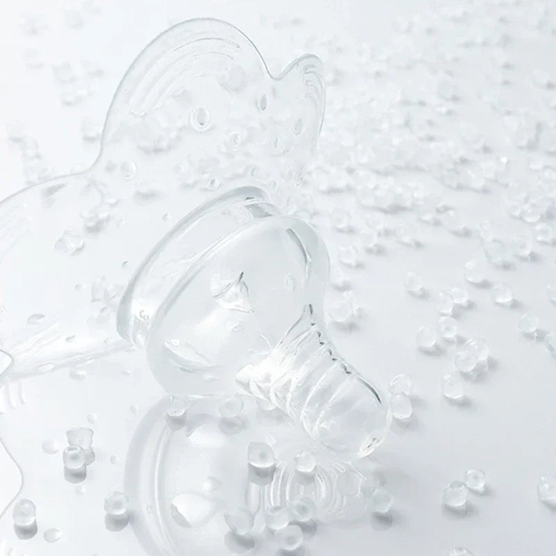 Clear silicone nipple shield for comfortable breastfeeding, surrounded by translucent beads.