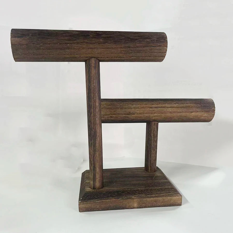 Dark brown wooden watch and jewelry organizer stand with two horizontal bars and a sturdy base.