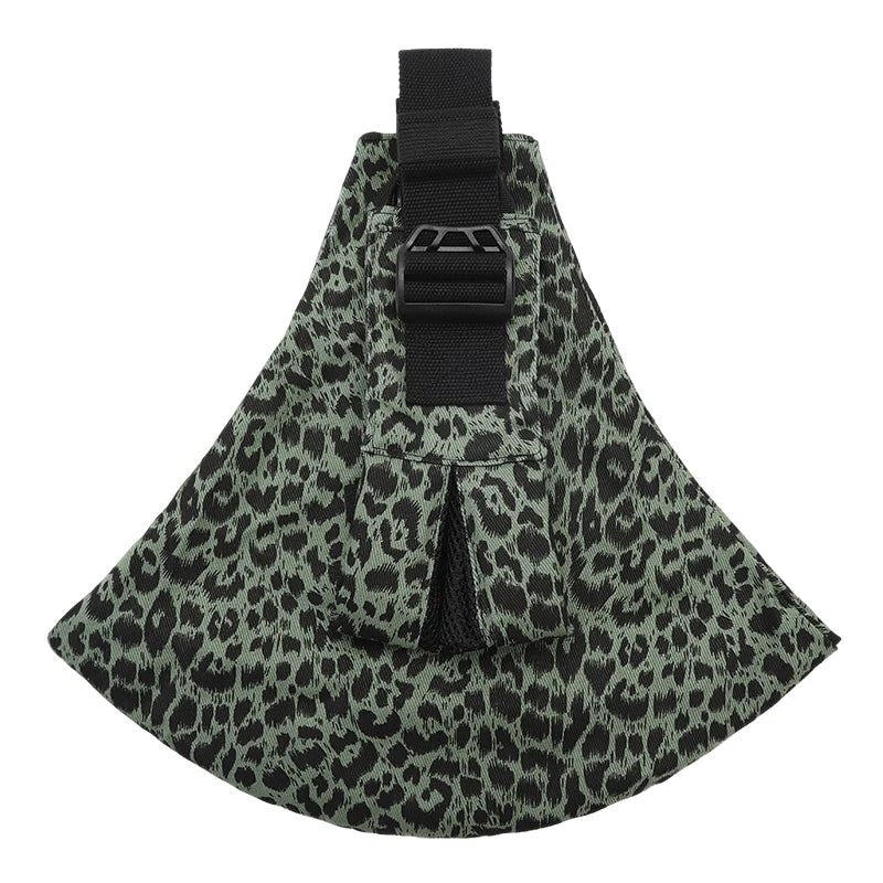 Ergonomic baby carrier in green and black leopard print with a wide black shoulder strap and buckle.