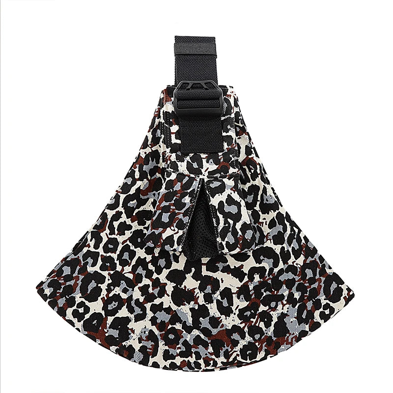 Ergonomic baby carrier with wide shoulder strap, leopard print fabric, and black buckle.