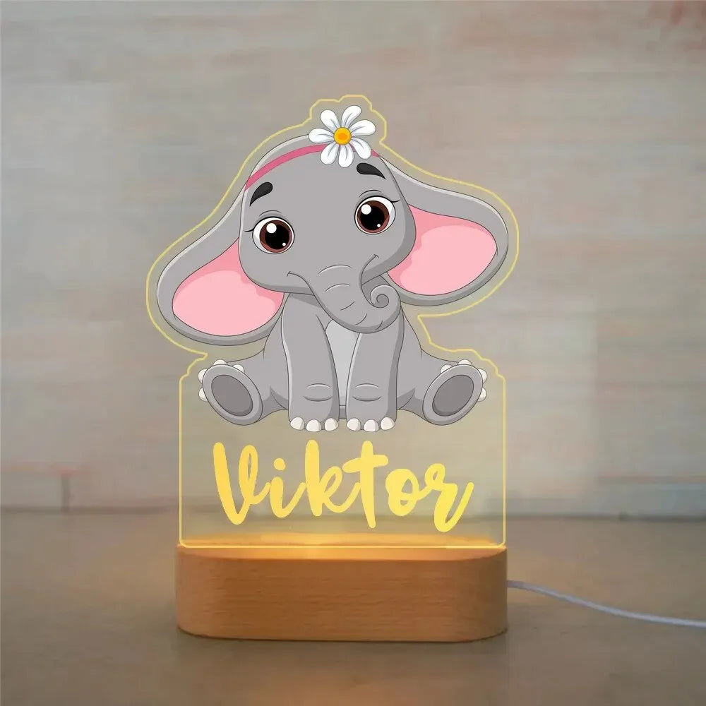 Personalized LED night light with a cute elephant design, wooden base, and "Viktor" engraved in yellow.