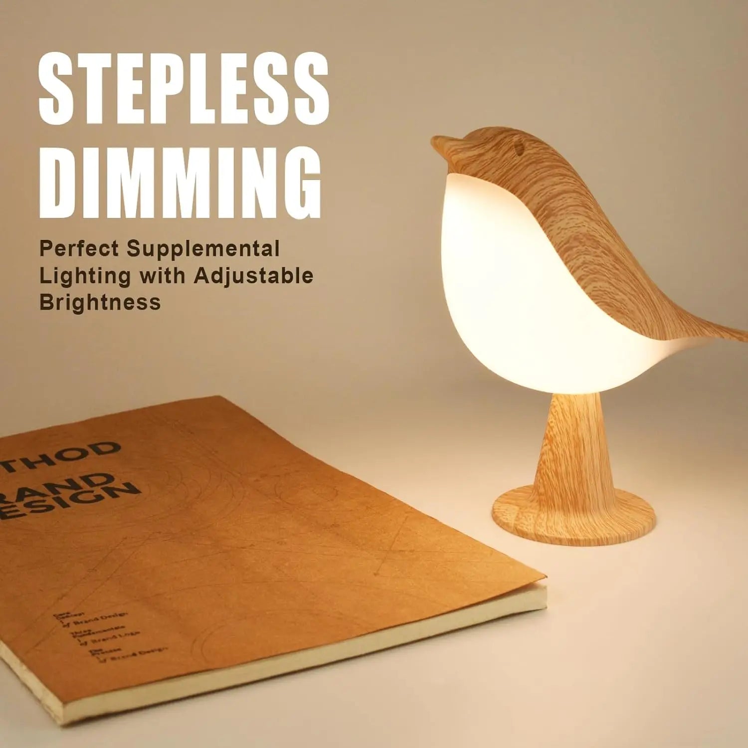 Wooden bird-shaped LED night light with soft, warm glow, next to a book.