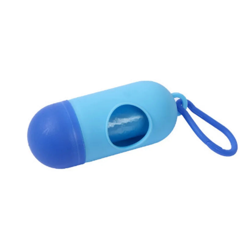 Blue capsule-shaped portable waste bag dispenser for diapers, with a darker blue cap and clip.