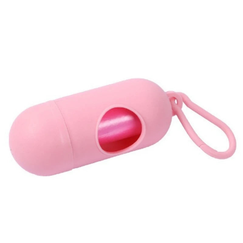 Pink capsule-shaped portable waste bag dispenser with a clip, ideal for diapers or pet waste.
