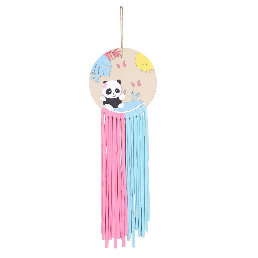 Wooden wall hanger with a panda, sun, and leaves, featuring pink and blue macrame tassels.