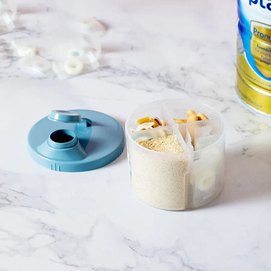 Portable 4-compartment baby food and formula dispenser with a blue lid, filled with snacks and powder.