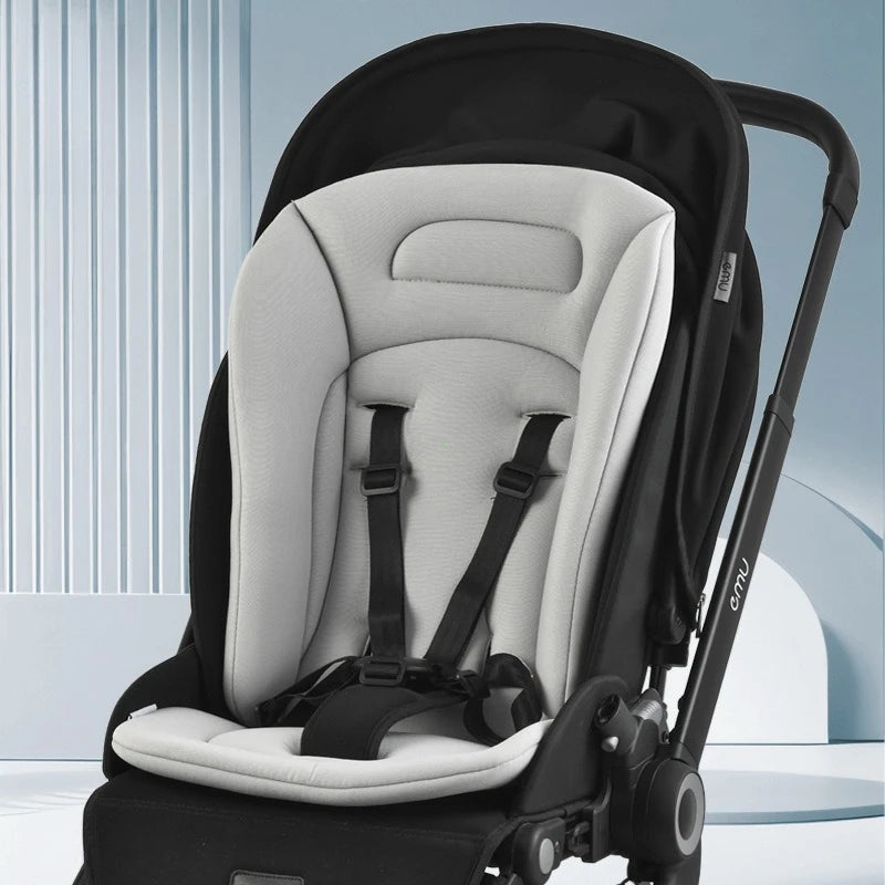 Light gray universal breathable cotton stroller mattress with black straps, in a black stroller.