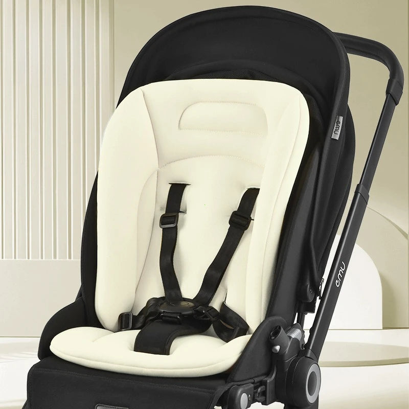 Cream cotton universal stroller mattress with black harness, 70x40cm, in a black stroller.
