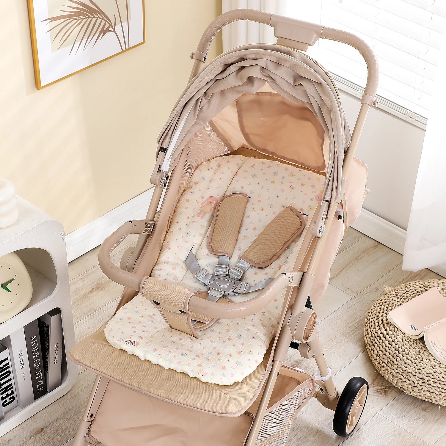 Beige stroller with a soft, floral-patterned cotton-polyester seat cushion and safety harness.