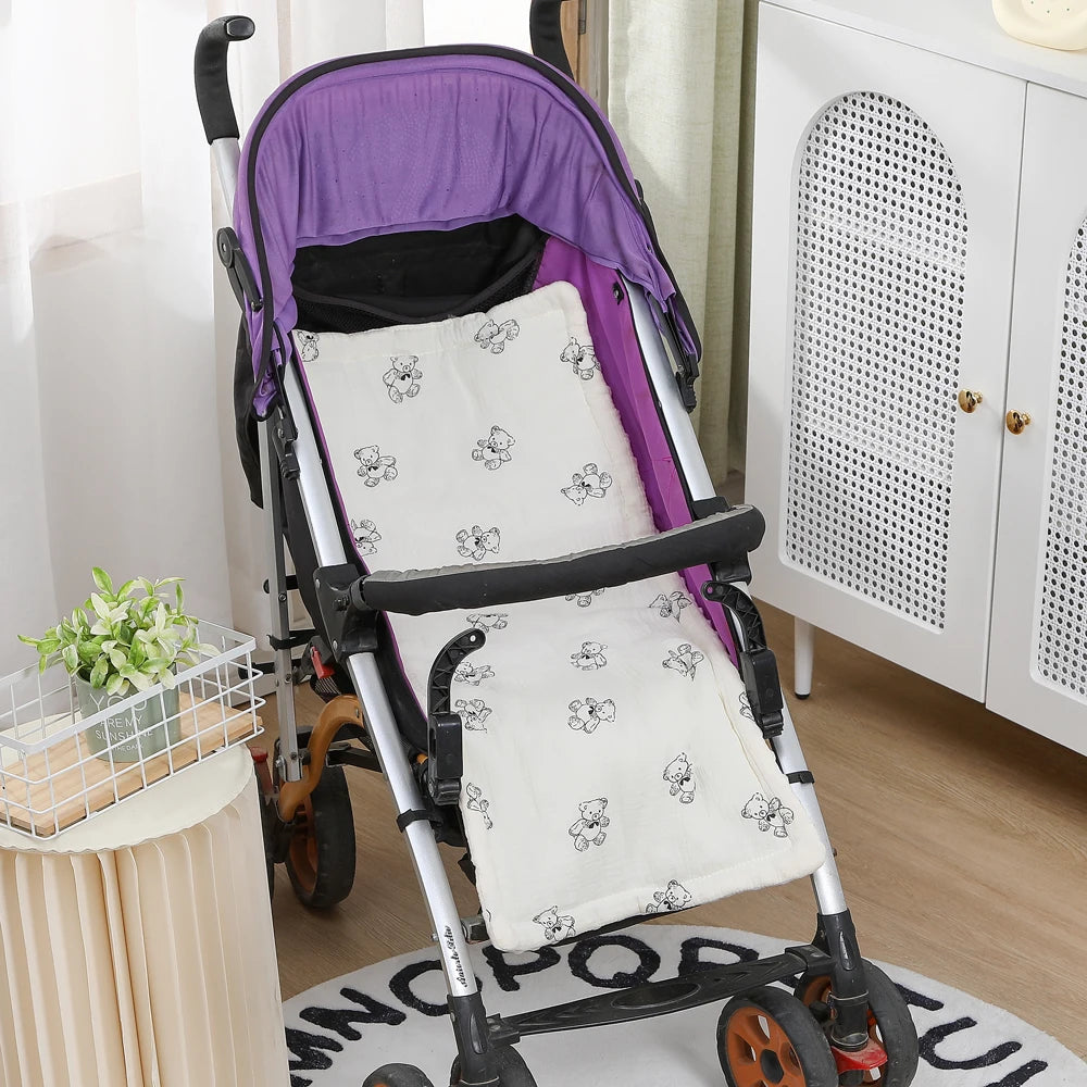 White cotton stroller cushion with black teddy bear print in a purple stroller.