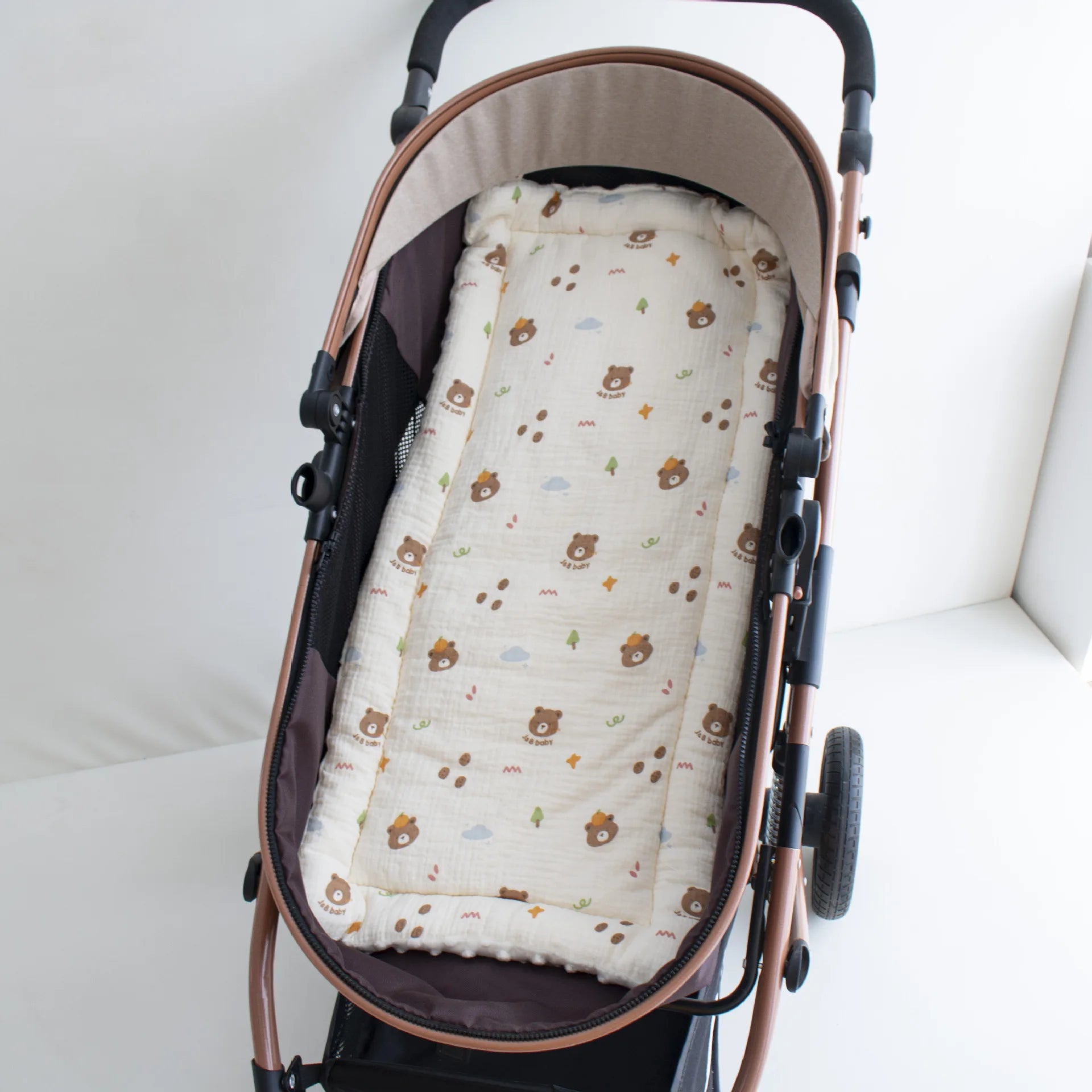Soft beige cotton stroller cushion with cute bear and tree print, universal fit.