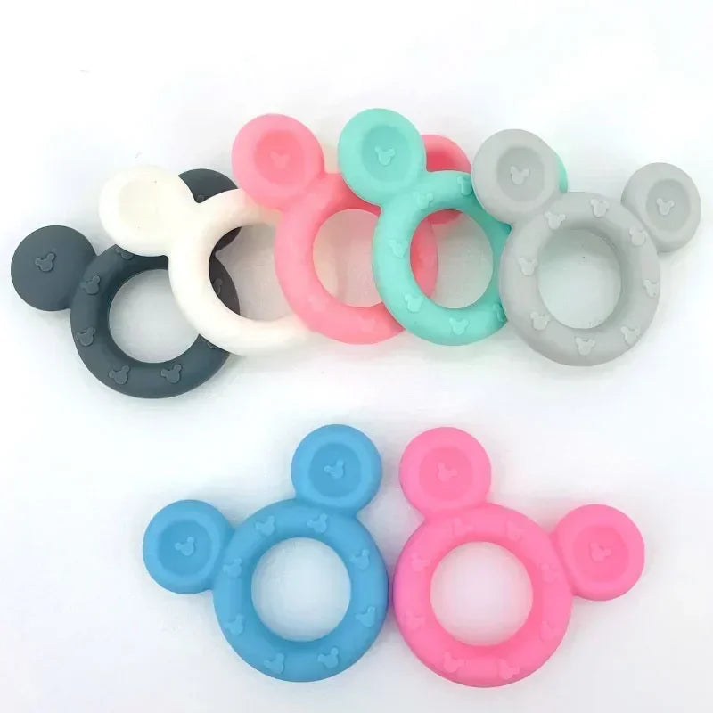 Colorful Mickey Mouse silicone baby teethers in various shades like pink, blue, gray, and white.