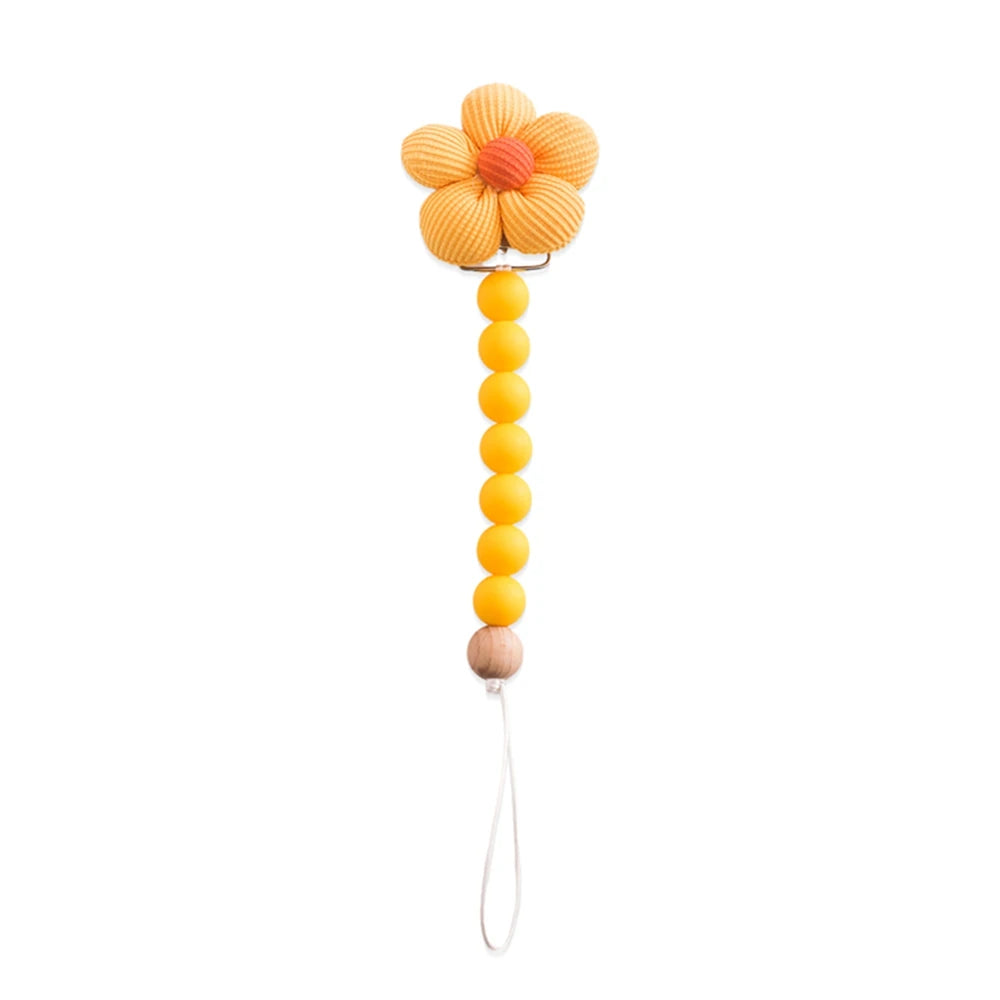 Yellow flower pacifier clip with silicone beads and a wooden accent.