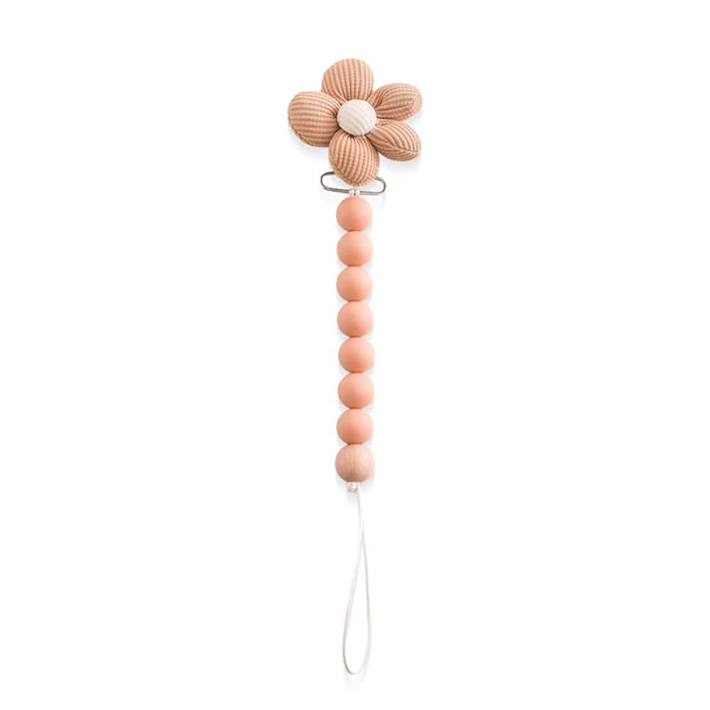 Pink silicone baby teether with a flower clip and beaded pacifier chain.