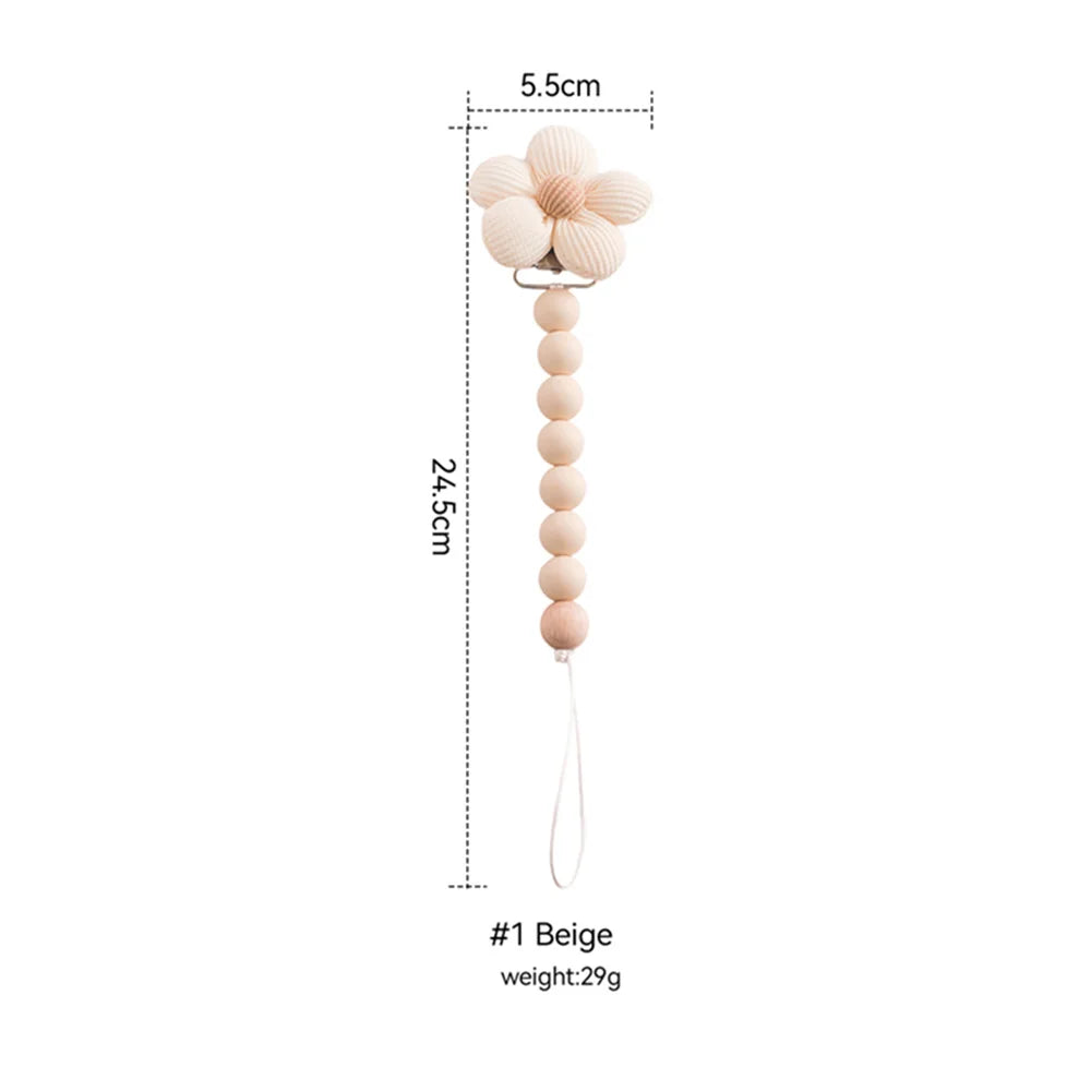 Beige silicone flower baby teether with wooden bead pacifier clip, 24.5cm long.