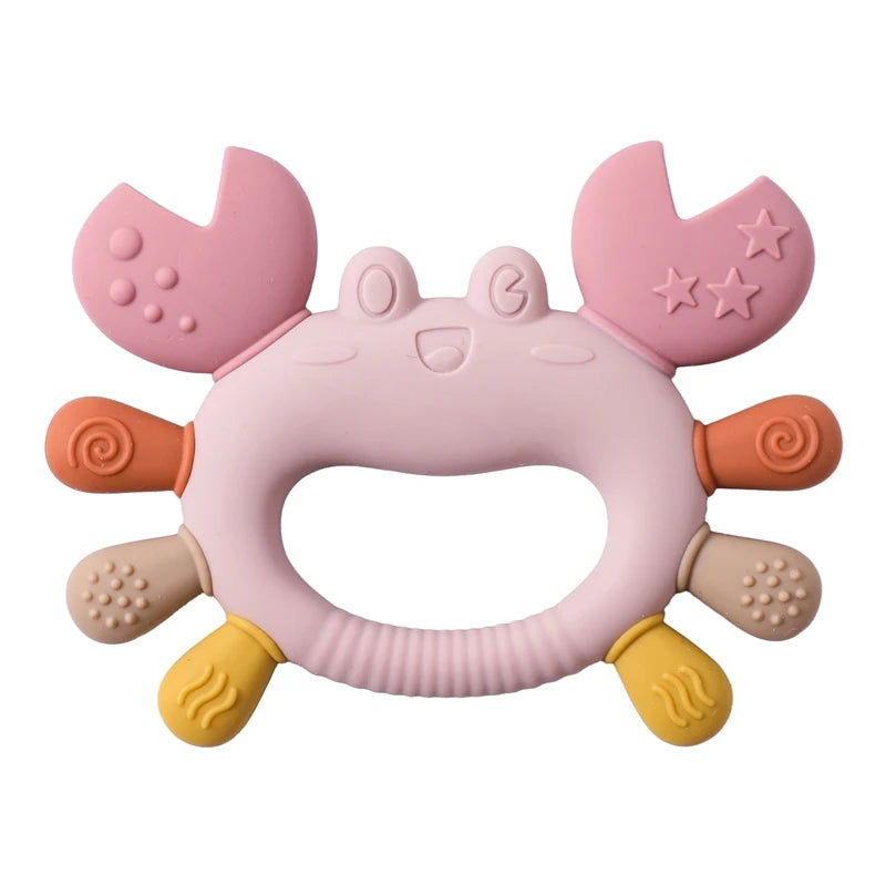 Pink silicone crab teether with textured claws and legs, ergonomic handle for babies.