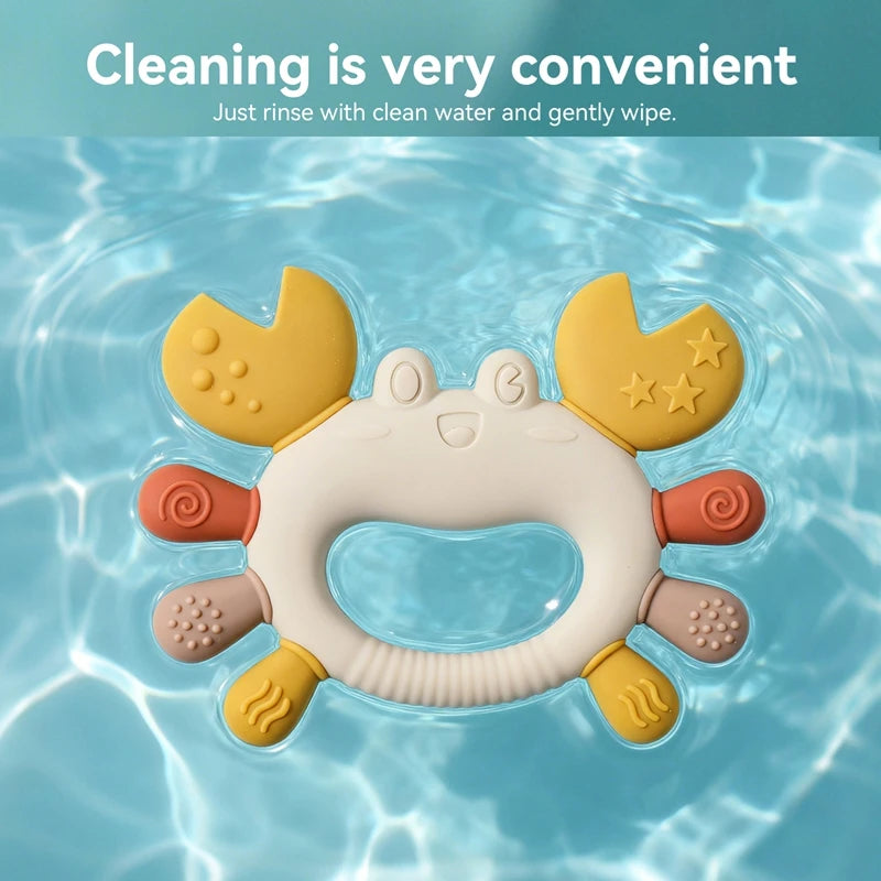 Colorful silicone crab teether floating in water, with textured claws and legs for soothing baby gums.