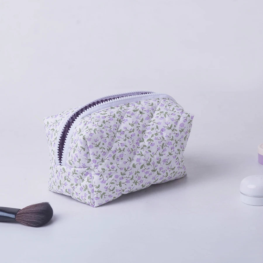 Quilted floral makeup bag with purple zipper, ideal for travel and daily use.