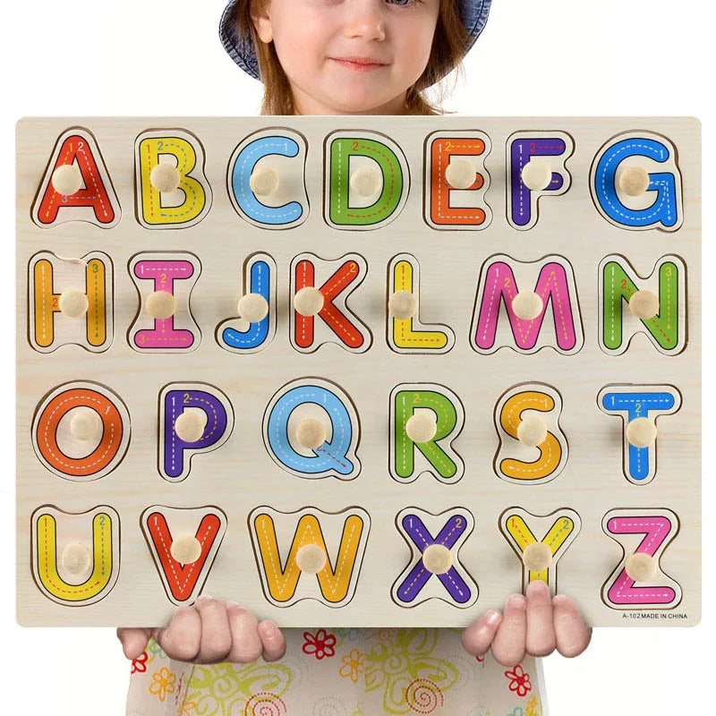 Child holding a colorful wooden Montessori alphabet puzzle board with uppercase letters.