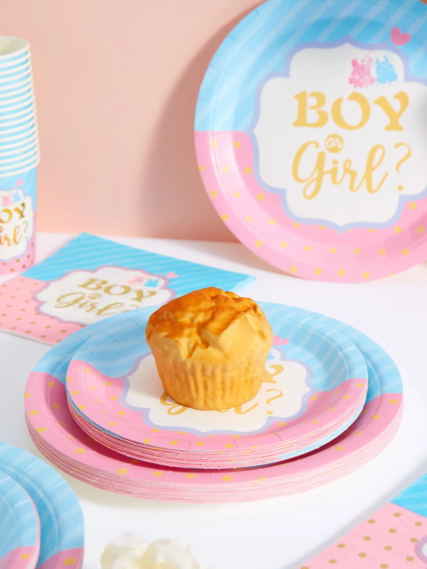 Pink and blue disposable plates, cups, and napkins for a gender reveal party, featuring "Boy or Girl?" text.