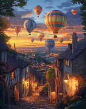 Paint by numbers kit: vibrant hot air balloons over a charming European town at sunset.