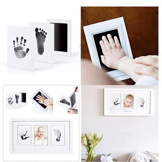 White no-touch baby handprint and footprint ink kit with black ink pad, shown with prints and a framed baby photo.