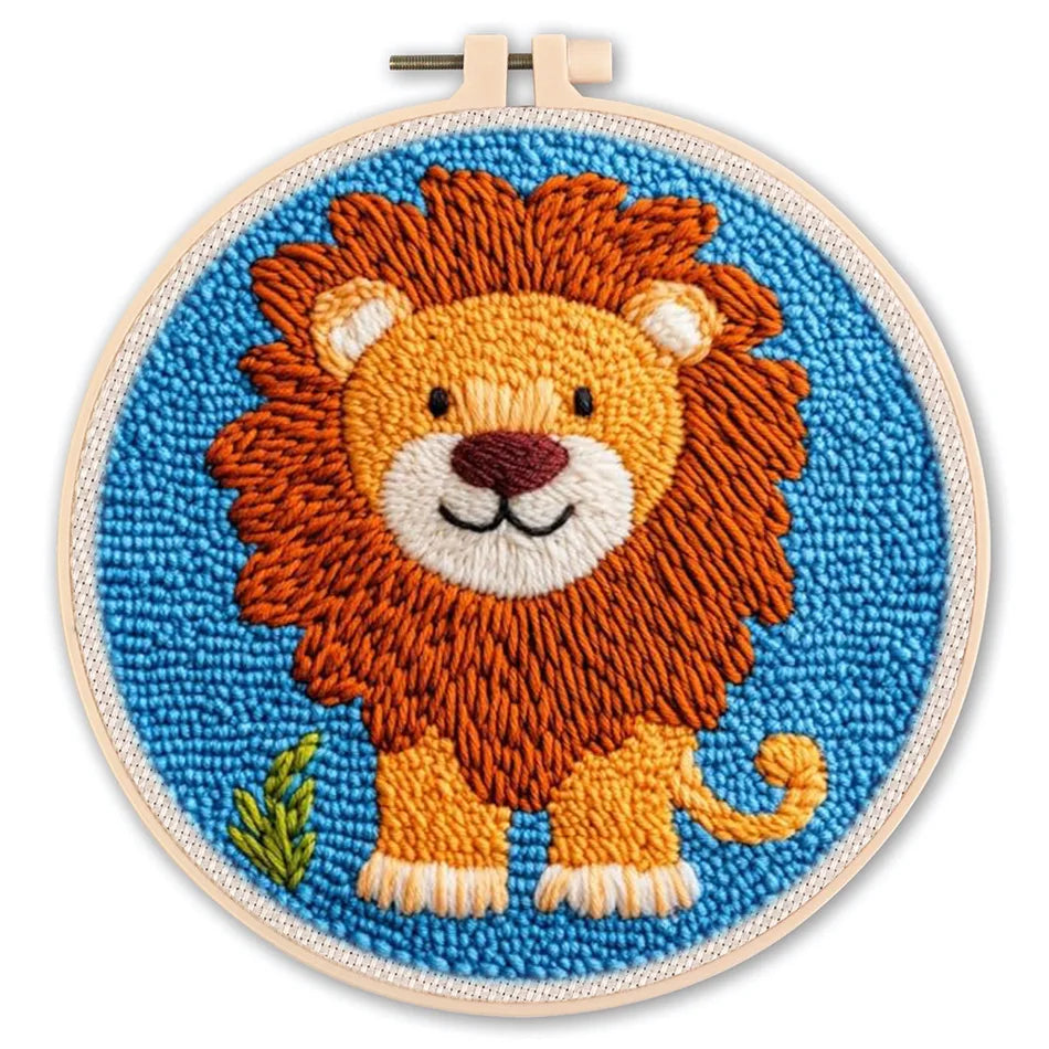 Punch needle embroidery kit featuring a cute orange lion on a blue background in a round hoop.
