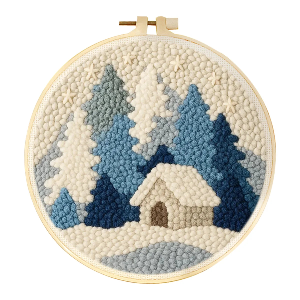 Punch needle winter landscape art kit with blue and white trees, a snowy cabin, and a wooden hoop.