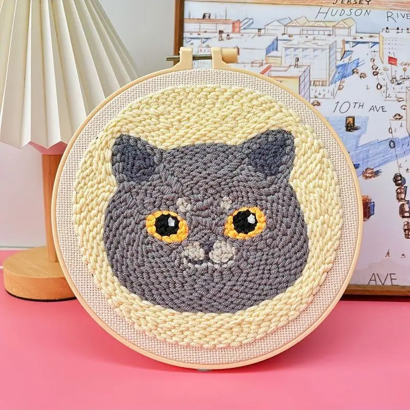 Punch needle embroidery kit with a cute gray cat design in a wooden hoop.