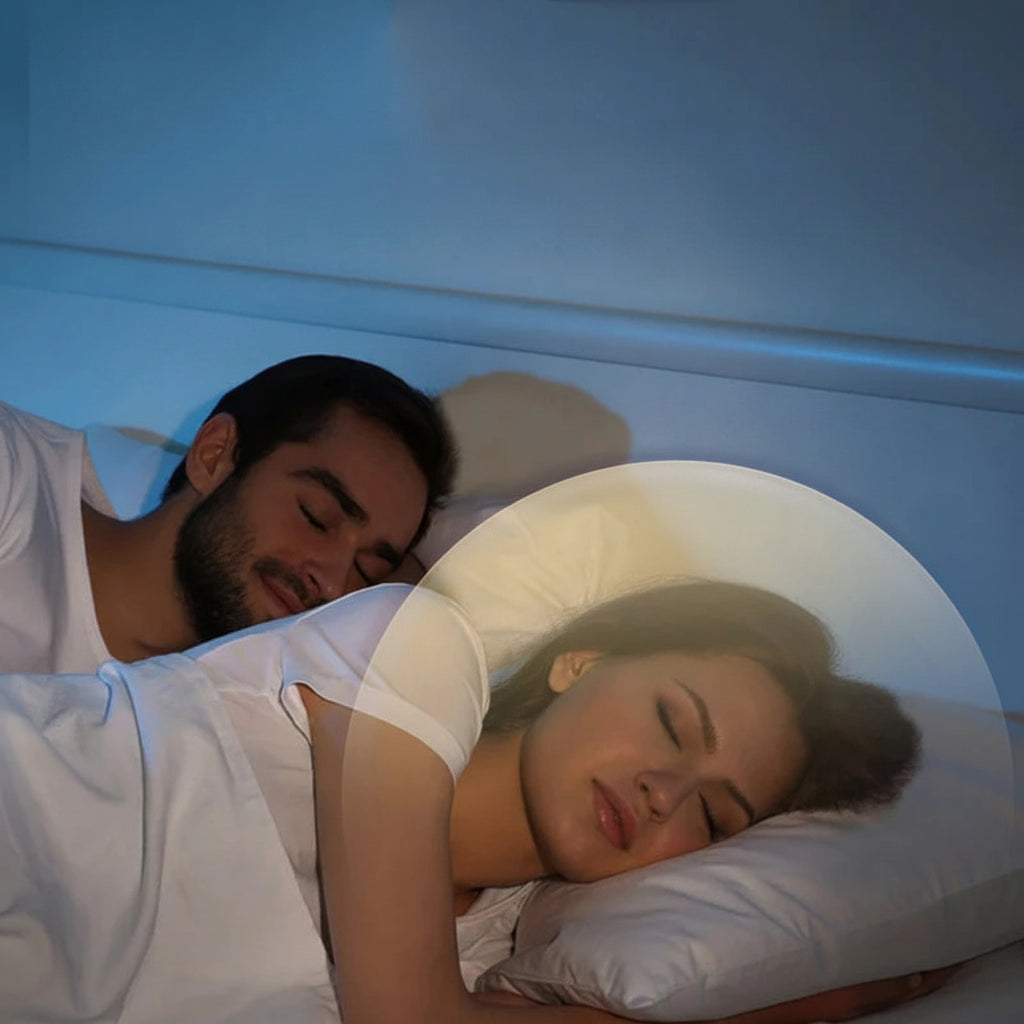 Couple sleeping peacefully with a white noise speaker under the pillow, showing 0dB and 10dB sound levels.