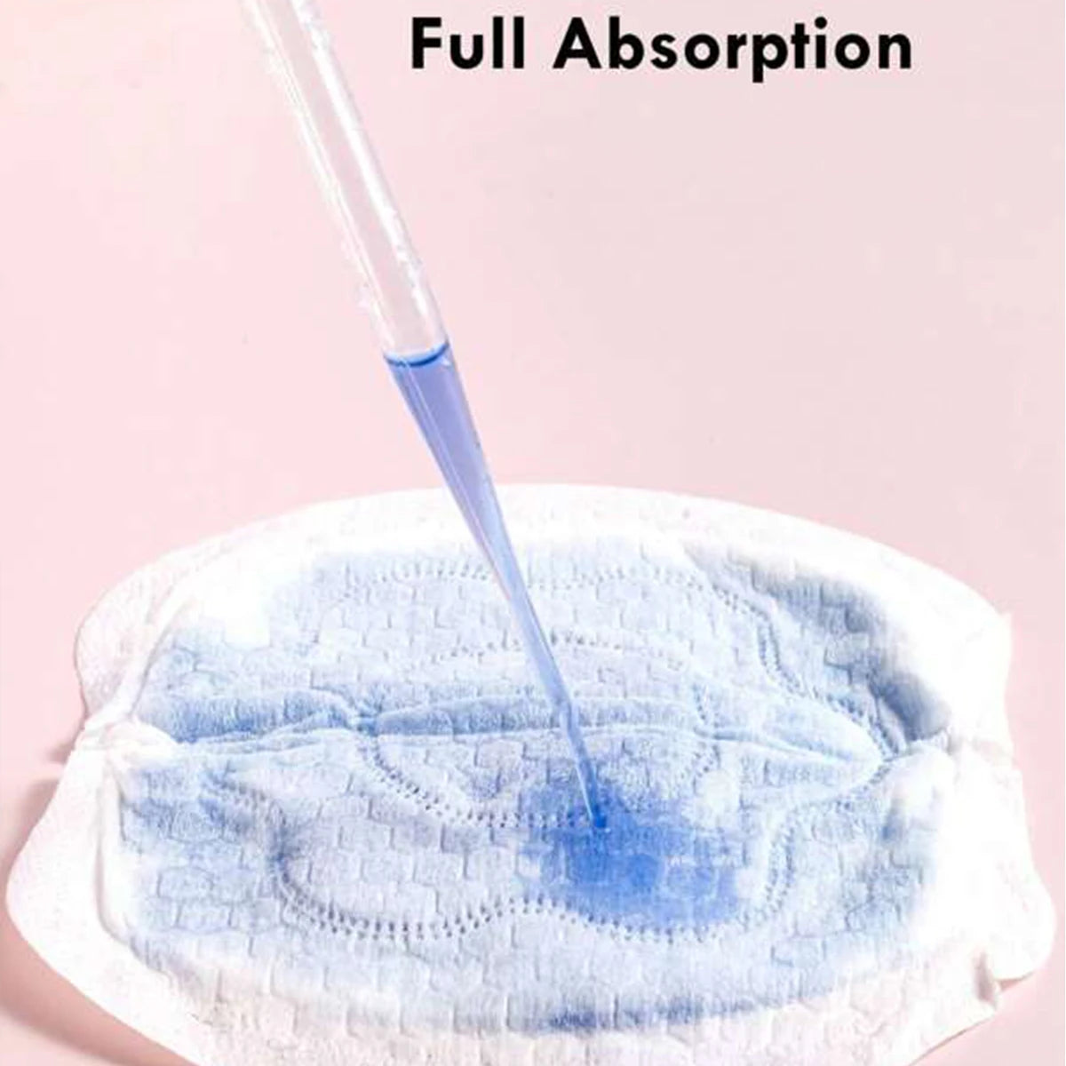 Disposable white nursing pad absorbing blue liquid from a dropper, demonstrating full absorption.