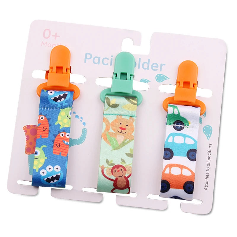 Set of 3 colorful baby pacifier clips with plastic clasps and fun monster, monkey, and car designs.