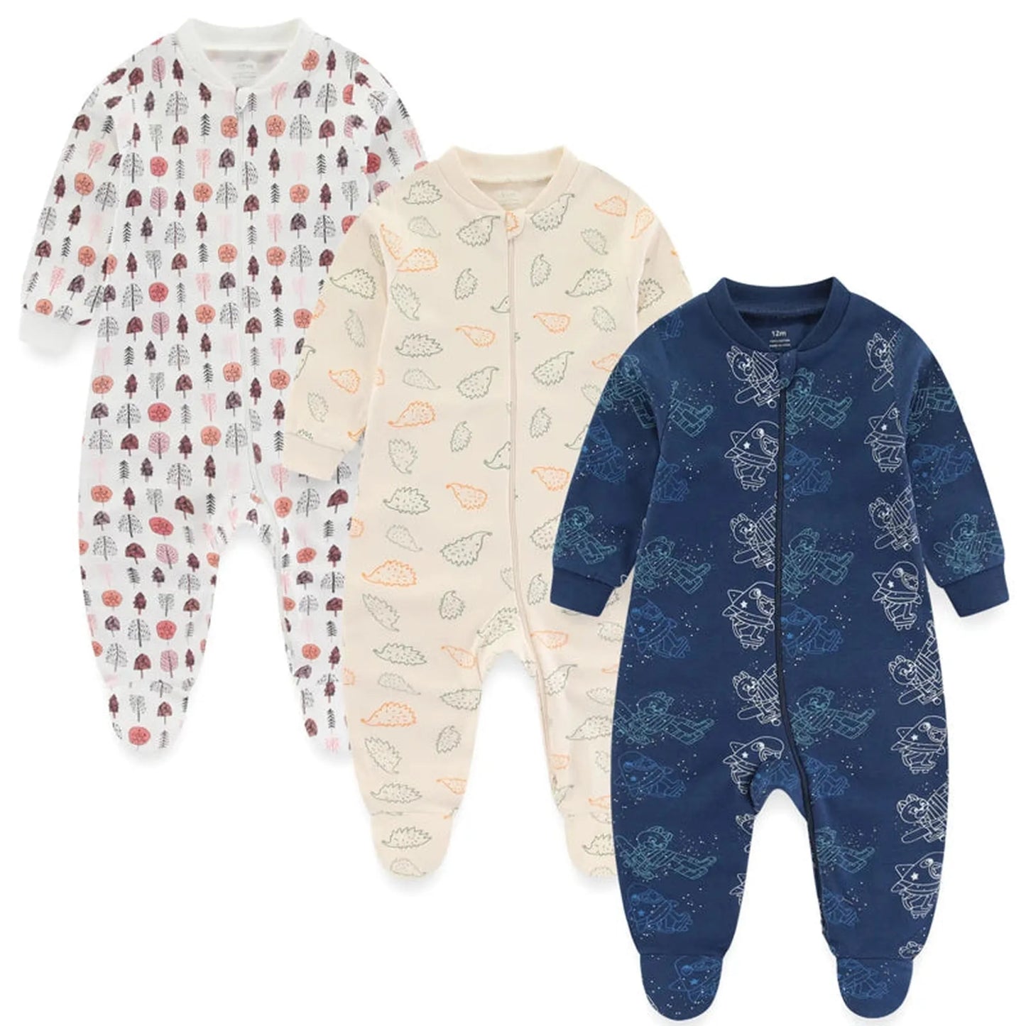 Three long-sleeve cotton baby rompers: white with trees, cream with hedgehogs, and navy with astronauts.