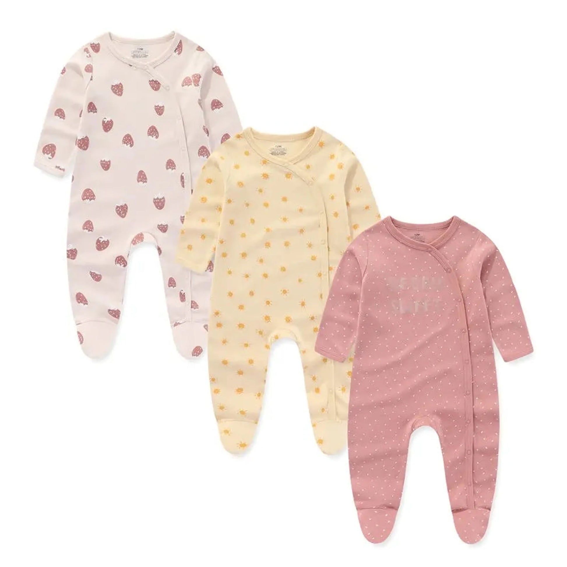Three long-sleeve cotton baby rompers: white with strawberries, yellow with suns, and pink with white dots.