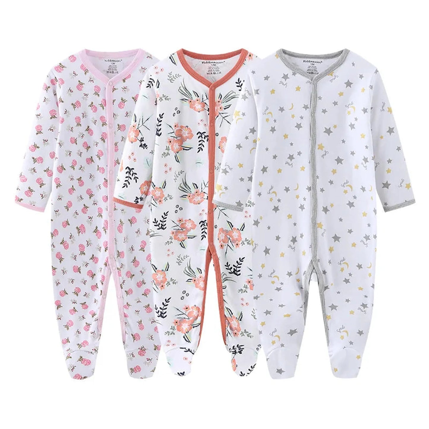 Three white long-sleeve cotton baby rompers with footies: pink floral, orange floral, and yellow star patterns.