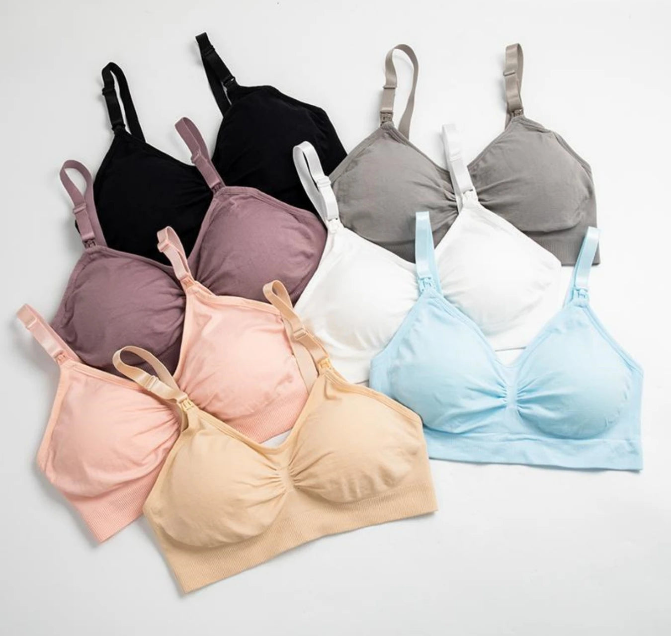 Seamless, breathable maternity and nursing bras in black, white, grey, blue, pink, and beige.