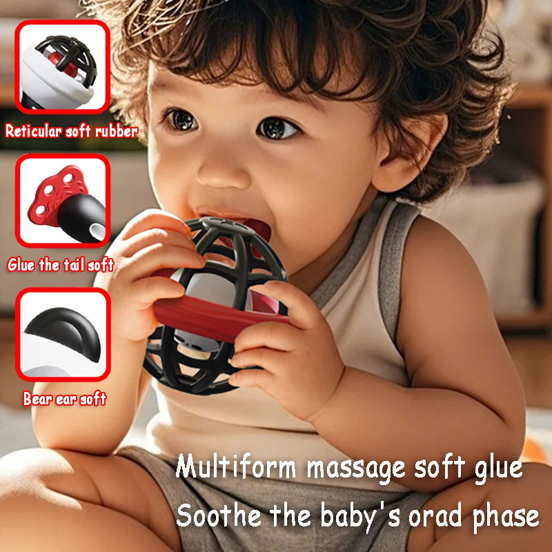 Baby chewing on a black and red Montessori musical rattle with soft, textured rubber for teething.