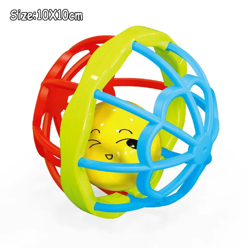Montessori musical rattle with a yellow smiling face inside a colorful red, green, and blue cage.